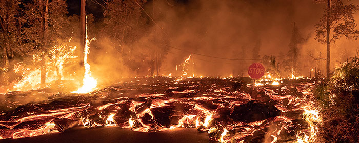 Trees on fire as lava moved through the area and smoke rises into the air