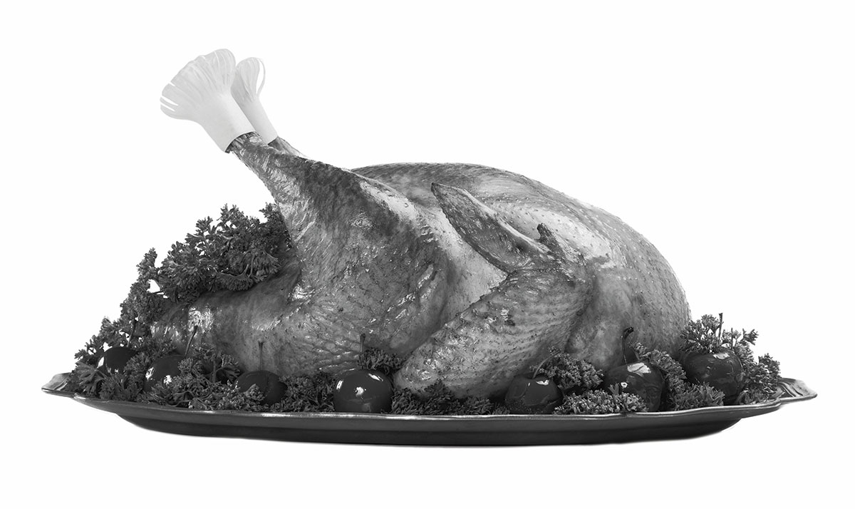 Black and white photo of a cooked turkey on a platter