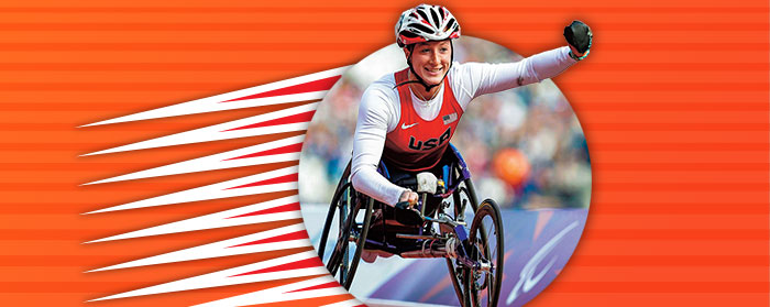 a woman in a racing wheelchair and helmet races in front of a textured orange background