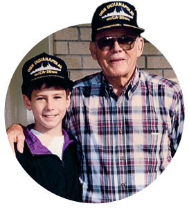 a boy and an older man pose for the camera
