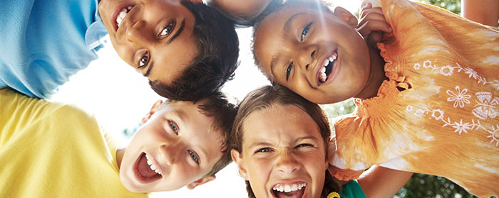 a group of kids smiling in a huddle