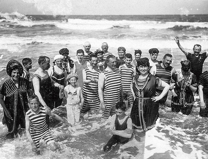 Enlargeable black and white photo of a family and friends posing for a picture in the ocean