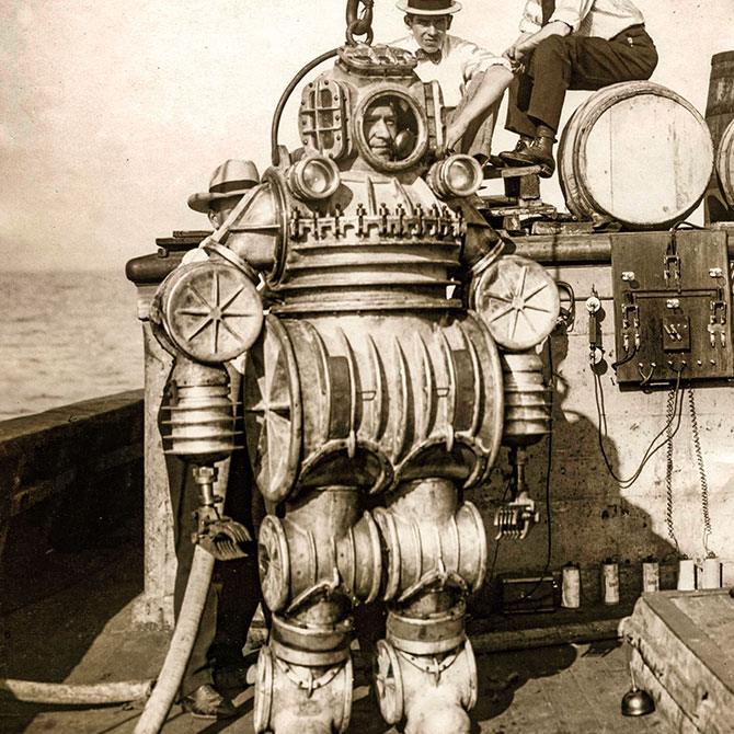 Enlargeable black and white photo of a man in a early model of a diving suit
