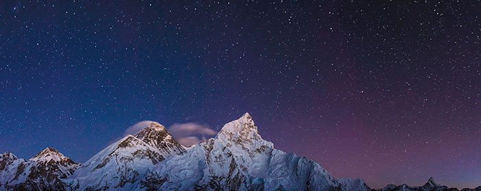 Mount Everest in front of a starry sky