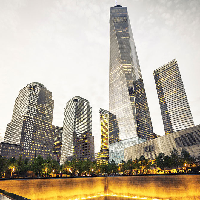 enlargeable picture of a tall skyscraper standing behind a memorial fountain