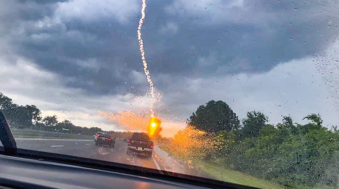 Photo of lightning strike taken by person in car on the highway