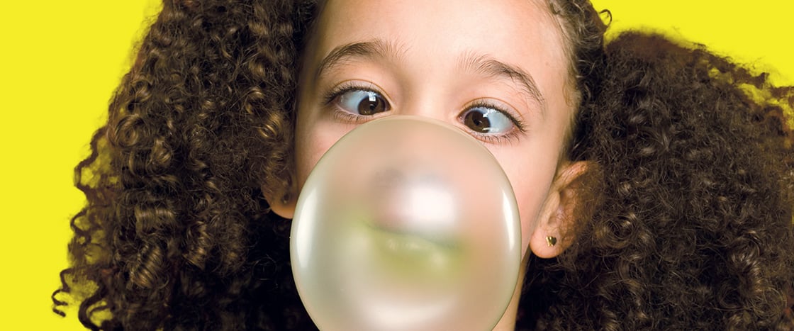 Image of a person blowing a bubble from gum